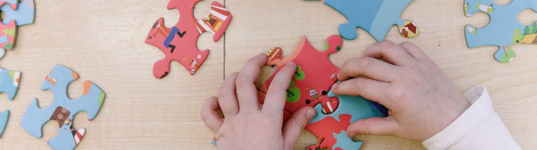 Hands putting puzzle pieces together